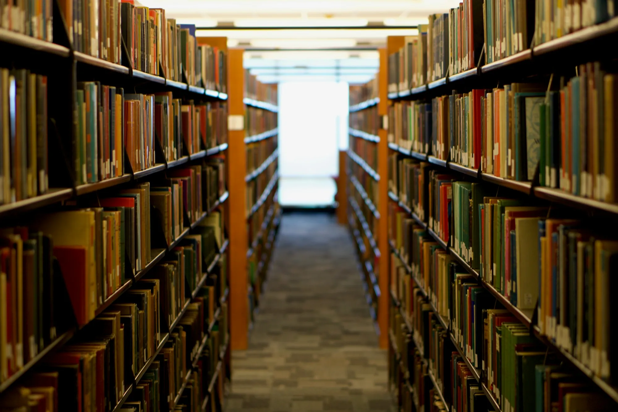 Long library aisle lined with bookshelves